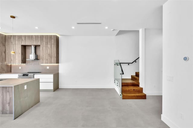 kitchen with light countertops, stainless steel electric range, baseboards, and modern cabinets