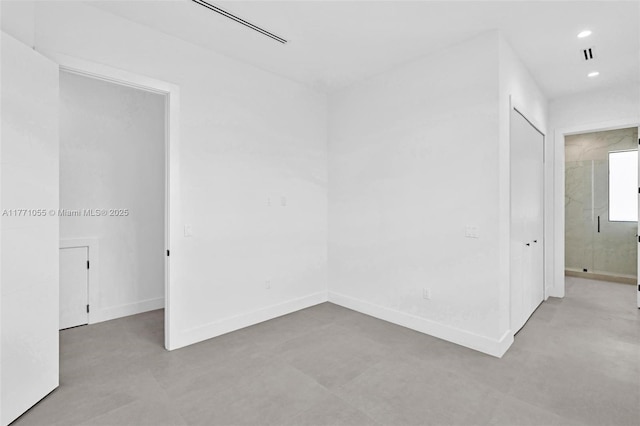 unfurnished room featuring baseboards, visible vents, and recessed lighting