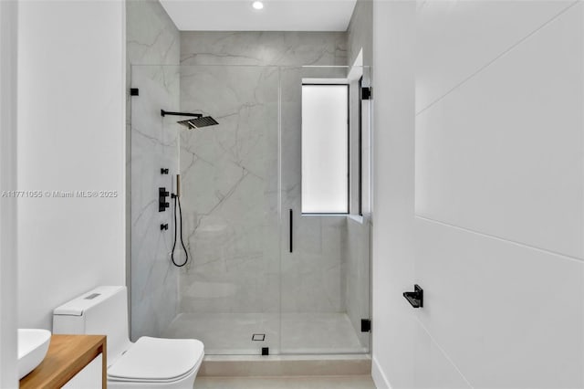 bathroom with recessed lighting, toilet, vanity, and a marble finish shower