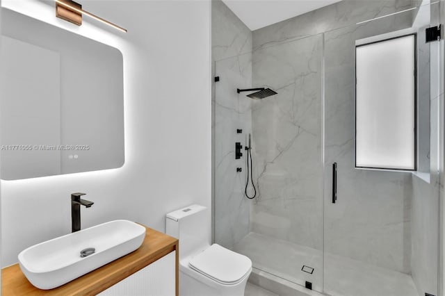 full bathroom with toilet, vanity, and a marble finish shower