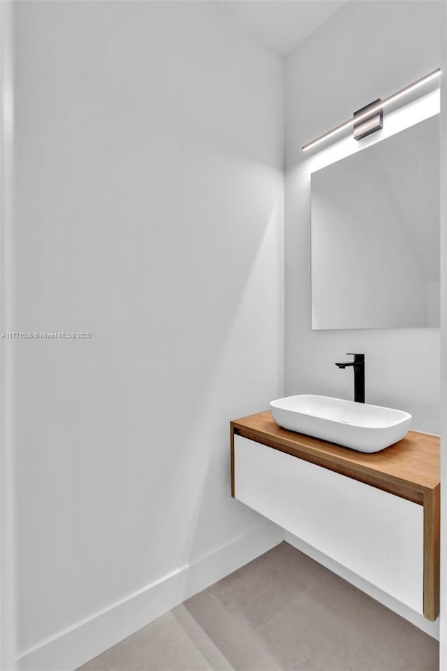 bathroom with vanity and baseboards