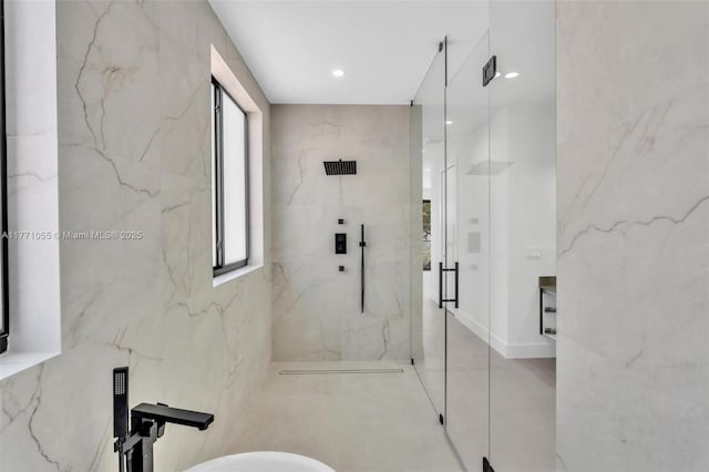 bathroom featuring a marble finish shower and recessed lighting