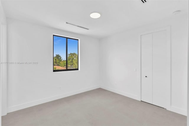 unfurnished bedroom featuring visible vents, baseboards, and a closet
