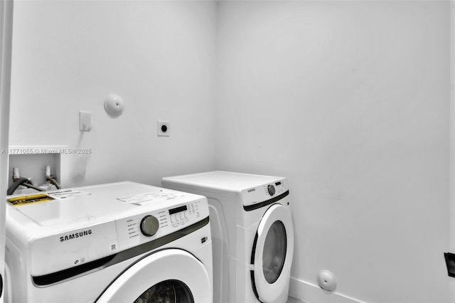 washroom featuring laundry area and washing machine and dryer