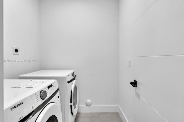 laundry room featuring washer and dryer, laundry area, and baseboards