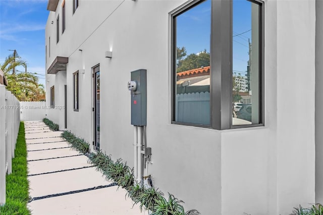 view of property exterior featuring fence and stucco siding