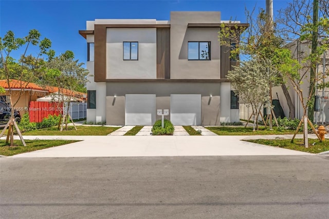 view of front of property featuring stucco siding, a garage, and concrete driveway