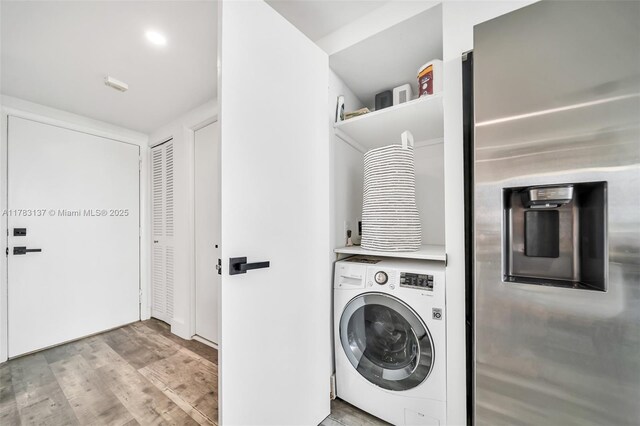 8233 Harding Ave Unit 607, Miami Beach, FL 33141 - laundry room with washer / dryer and wood finished floors