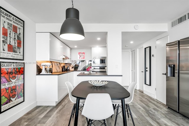 8233 Harding Ave Unit 607, Miami Beach, FL 33141 - dining room featuring light wood-type flooring and recessed lighting