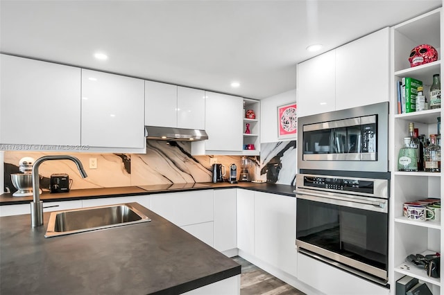 8233 Harding Ave Unit 607, Miami Beach, FL 33141 - kitchen featuring appliances with stainless steel finishes, open shelves, dark countertops, modern cabinets, and recessed lighting