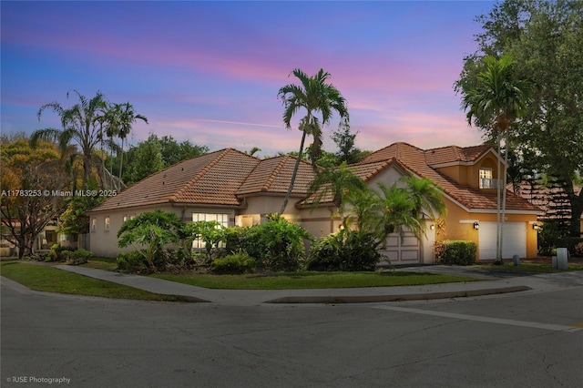 mediterranean / spanish home with stucco siding and a tile roof