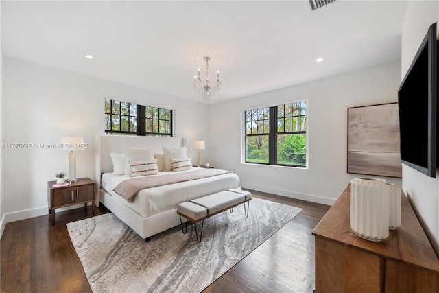 bedroom featuring a notable chandelier, multiple windows, and baseboards