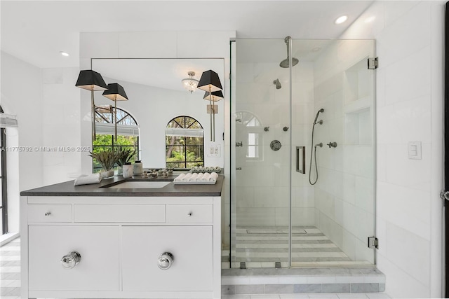full bath with a stall shower, vanity, and recessed lighting
