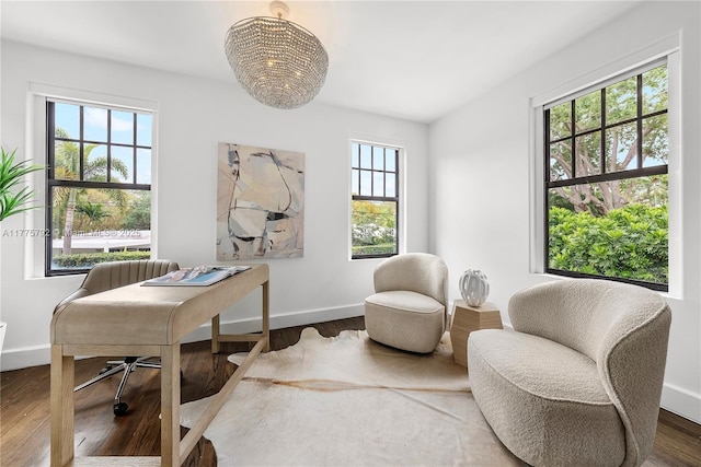 home office with wood finished floors, an inviting chandelier, and baseboards