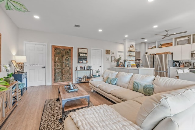 living area featuring light wood-style flooring, visible vents, recessed lighting, and ceiling fan
