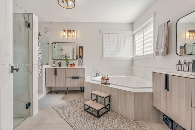 full bathroom with a bath, tile patterned floors, vanity, and a stall shower