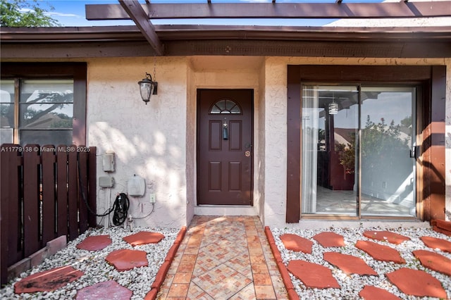 entrance to property with stucco siding