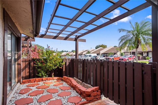 view of patio / terrace with a pergola, fence, and a residential view