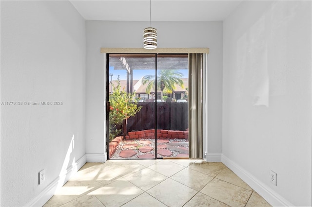 unfurnished dining area with baseboards