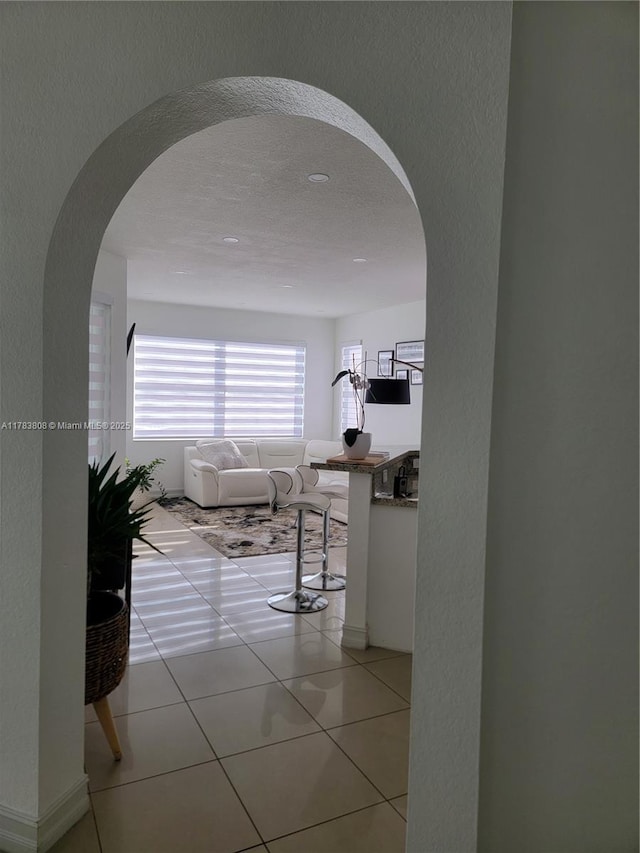 3708 NE 22nd Pl, Homestead, FL 33033 - hallway with arched walkways and light tile patterned floors