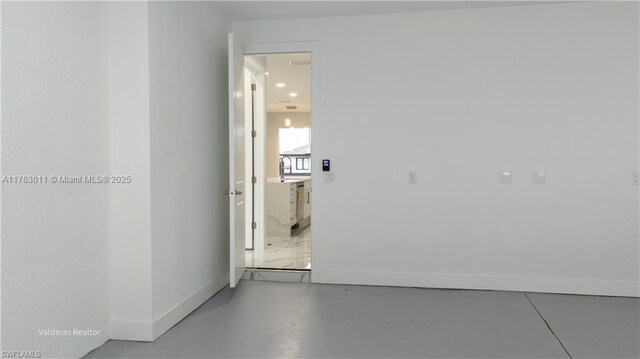 2901 27th St SW, Lehigh Acres, FL 33976 - corridor with concrete floors, a sink, and baseboards