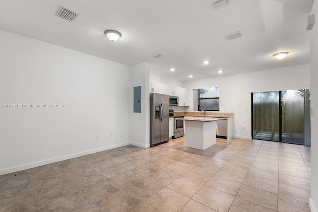 340 NE 208th Ter, Miami, FL 33179 - kitchen featuring a center island, appliances with stainless steel finishes, white cabinetry, and visible vents