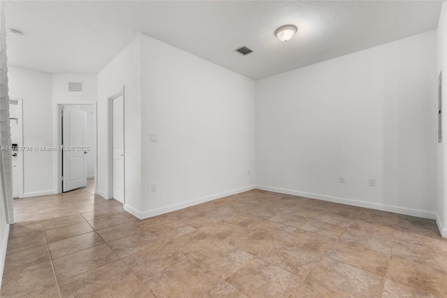 340 NE 208th Ter, Miami, FL 33179 - unfurnished room with light tile patterned floors, visible vents, and baseboards