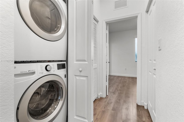 340 NE 208th Ter, Miami, FL 33179 - laundry area featuring laundry area, stacked washer and dryer, visible vents, wood finished floors, and baseboards