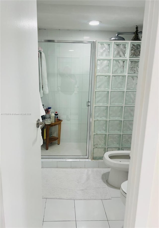 2333 Brickell Ave Unit 1516, Miami, FL 33129 - full bathroom featuring toilet, a stall shower, and tile patterned flooring