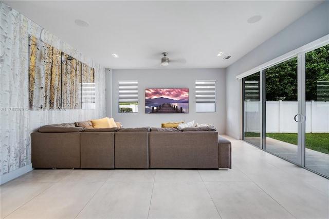 living room with a ceiling fan and light tile patterned flooring