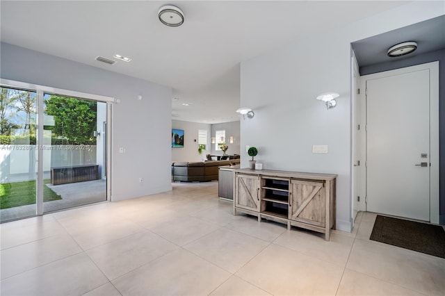interior space featuring visible vents and light tile patterned flooring