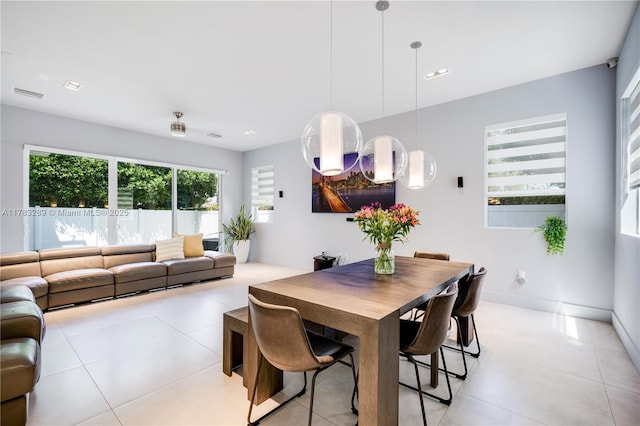dining area featuring light tile patterned floors, baseboards, and visible vents