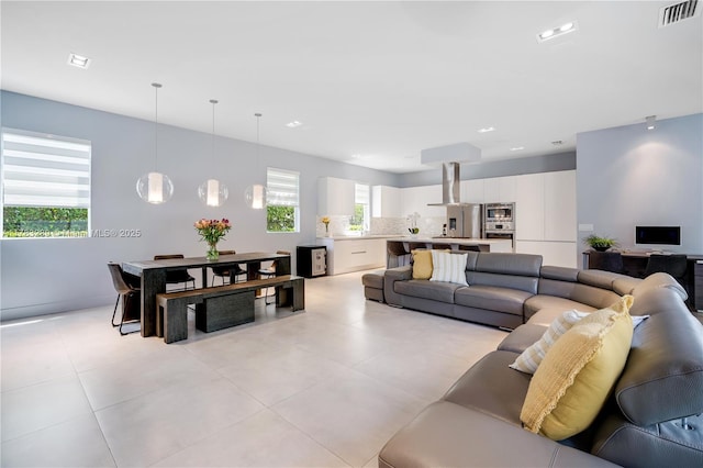 living room featuring visible vents and light tile patterned floors
