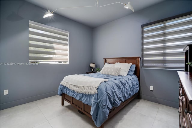bedroom featuring baseboards and tile patterned flooring