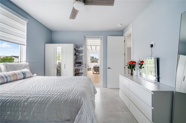 bedroom with light tile patterned floors and ceiling fan