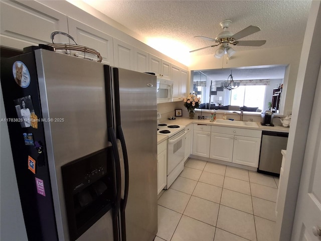 7751 Southampton Ter Unit 216, Tamarac, FL 33321 - kitchen featuring stainless steel appliances, a ceiling fan, a textured ceiling, white cabinetry, and light tile patterned floors