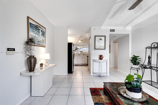 7751 Southampton Ter Unit 216, Tamarac, FL 33321 - living area with a ceiling fan, light tile patterned floors, and a textured ceiling