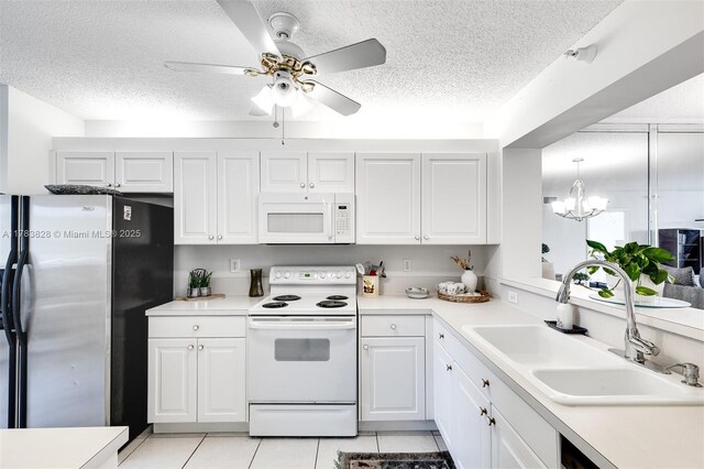 7751 Southampton Ter Unit 216, Tamarac, FL 33321 - kitchen with white appliances, a textured ceiling, a chandelier, ceiling fan, and light tile patterned floors