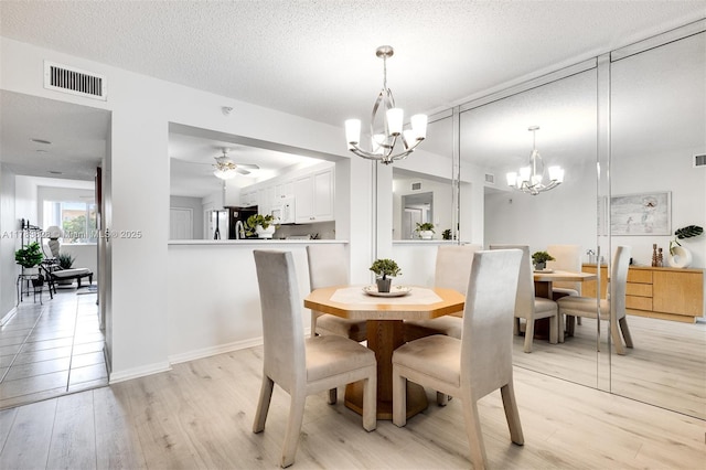 7751 Southampton Ter Unit 216, Tamarac, FL 33321 - dining area featuring a chandelier, light wood-style flooring, ceiling fan, and a textured ceiling