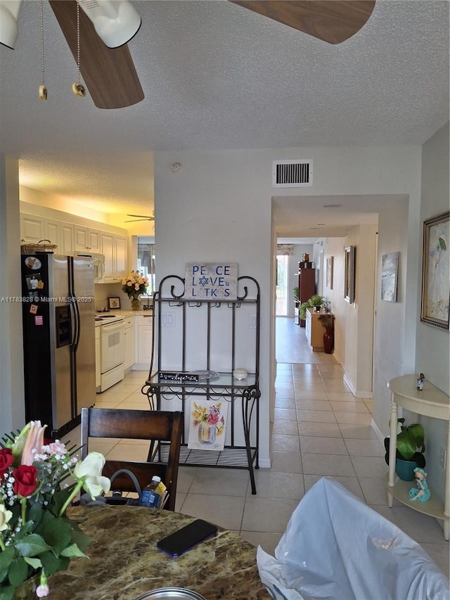 7751 Southampton Ter Unit 216, Tamarac, FL 33321 - dining room with light tile patterned floors, a textured ceiling, and baseboards