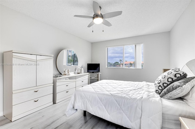 7751 Southampton Ter Unit 216, Tamarac, FL 33321 - bedroom featuring light wood-style floors, a textured ceiling, and ceiling fan