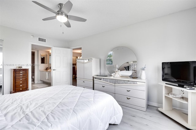 7751 Southampton Ter Unit 216, Tamarac, FL 33321 - bedroom featuring light wood-style flooring, ensuite bathroom, and a ceiling fan