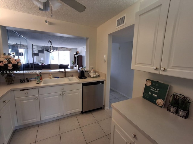 7751 Southampton Ter Unit 216, Tamarac, FL 33321 - kitchen featuring stainless steel dishwasher, a sink, a textured ceiling, light tile patterned floors, and white cabinetry
