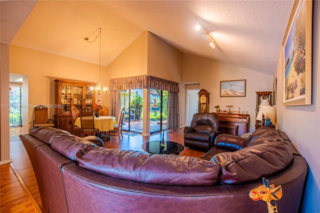 17411 NW 62nd Ct, Hialeah, FL 33015 - living area featuring wood finished floors, a notable chandelier, lofted ceiling, and plenty of natural light