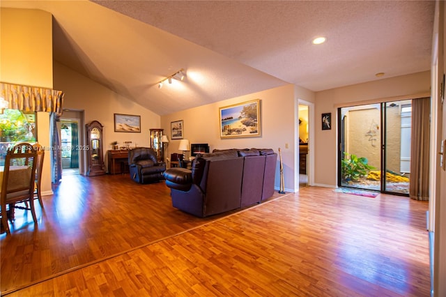 17411 NW 62nd Ct, Hialeah, FL 33015 - living room featuring baseboards, vaulted ceiling, recessed lighting, a textured ceiling, and wood finished floors