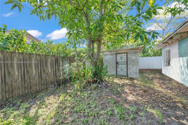 view of yard with an outbuilding and a fenced backyard