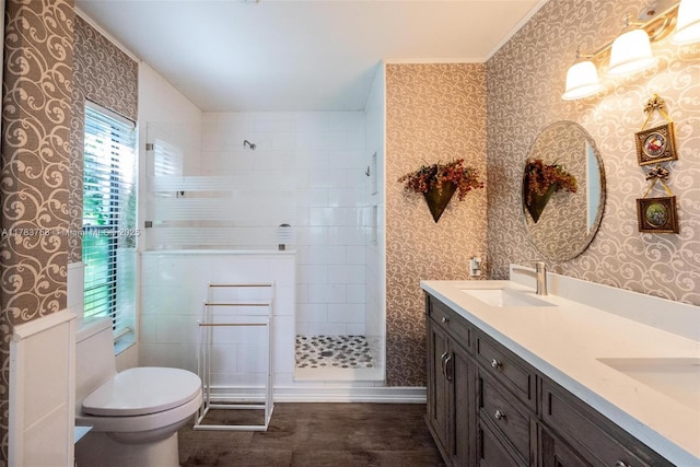 9909 NW 52nd Ln, Doral, FL 33178 - bathroom featuring wallpapered walls, double vanity, toilet, walk in shower, and crown molding