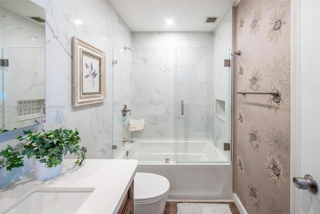 9909 NW 52nd Ln, Doral, FL 33178 - bathroom featuring vanity, bath / shower combo with glass door, and toilet