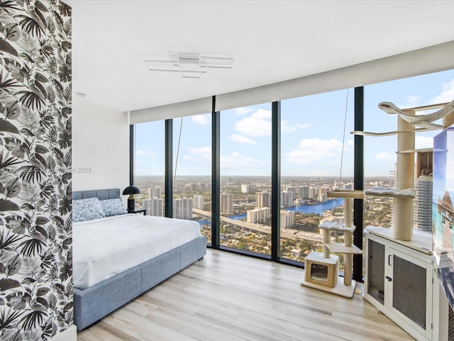 18555 Collins Ave Unit 5505, Sunny Isles Beach, FL 33160 - bedroom with a wall of windows, a water view, wood finished floors, and access to outside