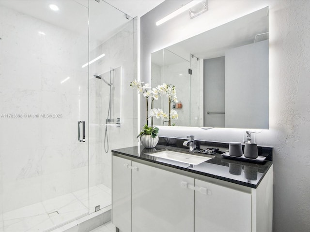 18555 Collins Ave Unit 5505, Sunny Isles Beach, FL 33160 - bathroom with a stall shower, vanity, and a textured wall